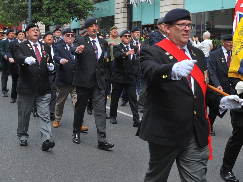 Military personnel march down the Headrow.