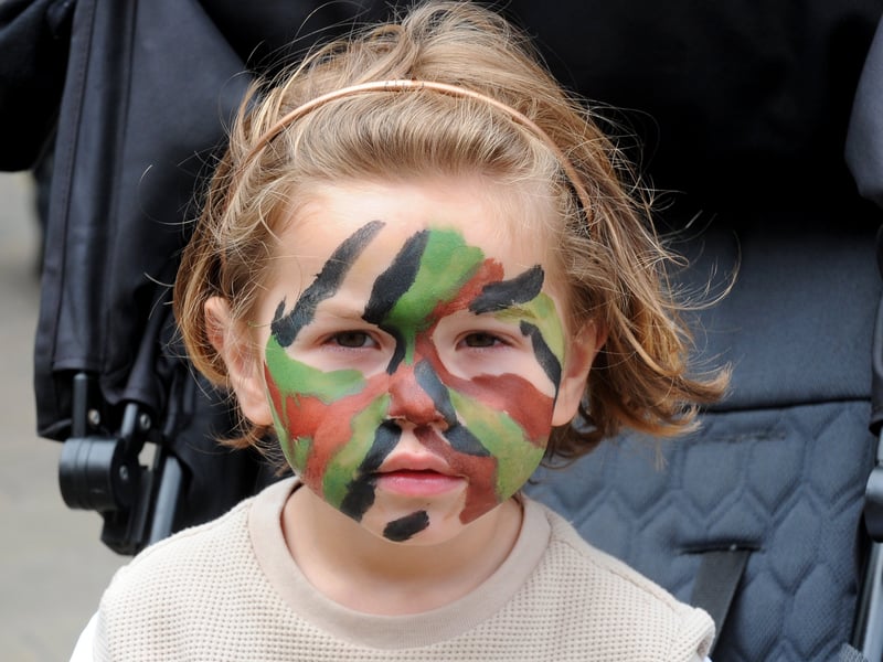 Camo face paint for young soldier Romeo Lambert, three, of Leeds.
