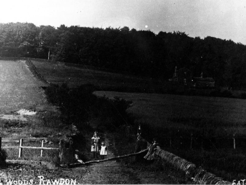 Rawdon Billing, a hillside, wooded in parts, which rises to 750 ft. It is believed an ancient gold torque was found here but there is no record of what happened to it. There is evidence of gritstone quarries. This view is to the north, with Billing House on the right. A group of children can be seen in foreground.