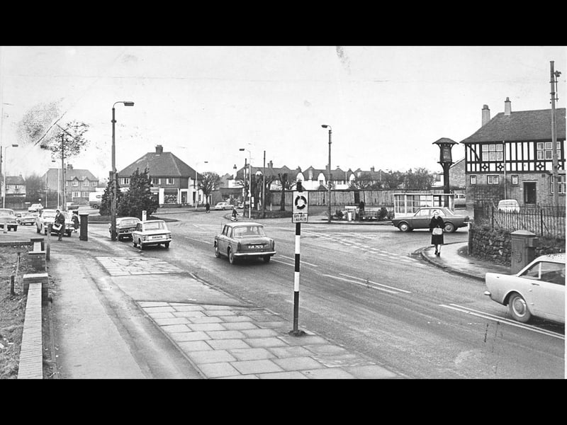 Classic 1960s saloons navigate the busy roundabout junction linking Coalway Road and Trysull Road in 1969. Standing prominently on the right is the timber-framed Merry Hill public house, a popular local landmark and favourite gathering place for generations of nearby residents. The bustling street scene captures the everyday rhythm of suburban life in south-west Wolverhampton during a time of steady growth and increased motor traffic. Do you have memories of visiting the Merry Hill pub or driving through this junction back in 1969?