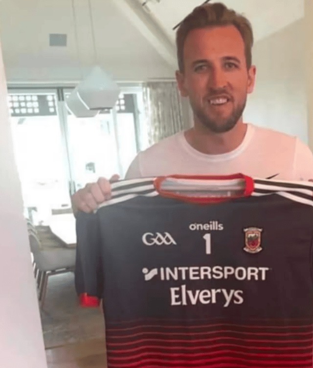 Harry Kane holding a Mayo jersey