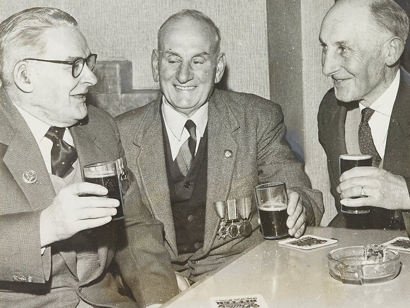 Three Great War veterans share a pint of ale and a laugh at the annual reunion of the 5th and 7th Battalions of the South Staffordshire Regiment, held at the Drill Hall in Walsall in May 1965. Pictured from left to right are Bert Sanders, who joined the 5th Battalion in 1910, John Woodcock, who enlisted in 1914, and Frank Barker, who signed up in 1913. Wearing their service badges and campaign medals with pride, the old comrades toast lifelong friendships forged in service to their country. Do you have any family members who served with the South Staffordshire Regiment or attended reunions at the Drill Hall?