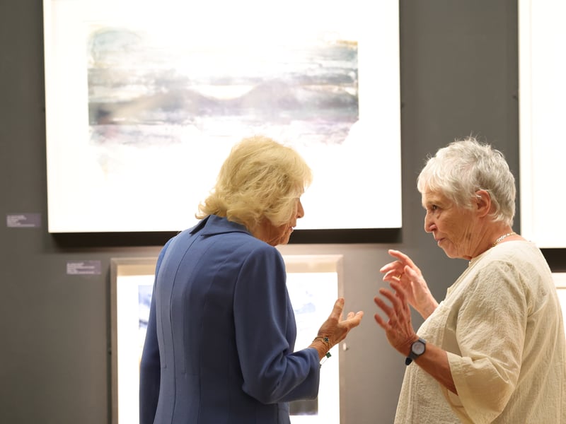 Queen Camilla speaking to artists during her visit to see the exhibition