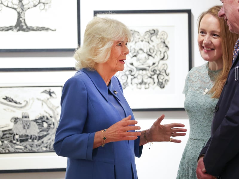 Queen Camilla speaking to artists during her visit to see the exhibition