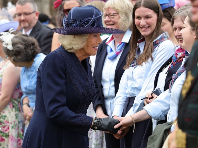 Queen Camilla speaking to guests during the annual Garden Party in the gardens of the Palace of Holyroodhouse