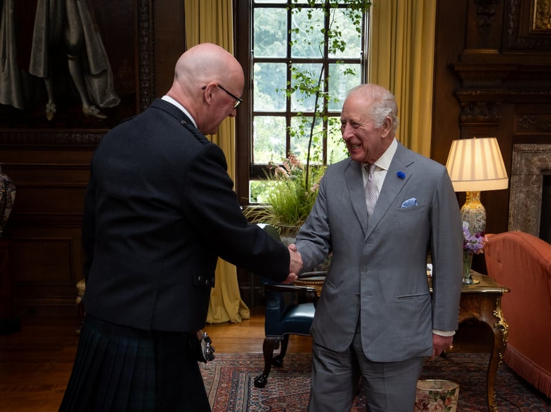 King Charles III greets the First Minister John Swinney during an audience at the Palace of Holyroodhouse 