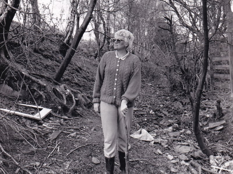 March 1989 and residents of a Whinmoor housing development were fighting to save neglected Roman road . Resident June Norcliffe is pictured walking on the 7ft wide road which was overgrown and littered with dead trees, stones, rubbish and builders' waste.