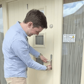 Oliver Murray turning the key in his brand new home