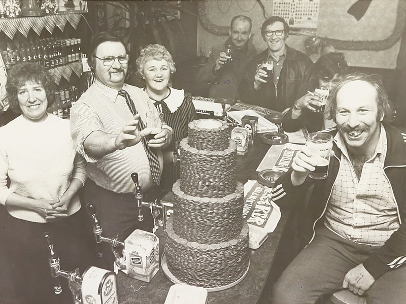 A pub effort in Walsall! Licensee Fred Clarke and his wife Pat join jovial regulars at the Spring Cottage Pub in Bloxwich on April 26, 1983, to push over a massive multi-tiered tower of copper coins. Built up over several months, the giant pile of pennies was created to raise vital funds for the Wolverhampton branch of the Royal National Lifeboat Institution, with local drinkers having a grand time guessing the final total before the big push.