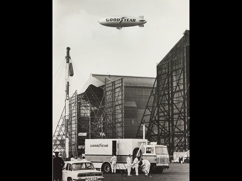 The Europa airship drifts above the Goodyear factory in Wolverhampton in the 1980s, creating a striking contrast between modern advertising and the town’s industrial landscape. With the factory buildings and working yards below, the photograph captures a memorable moment above one of Wolverhampton’s major industrial sites. Do you remember seeing the Europa flying over Wolverhampton? Did it ever pass overhead and make you stop and look up?