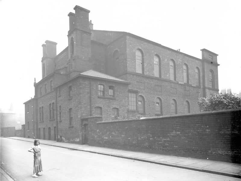 A young girl looks towards the camera outside Queen Street Congregational Chapel in August 1936.