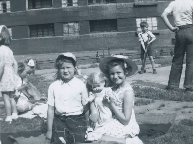 Young children playing outside Quarry Hill Flats.