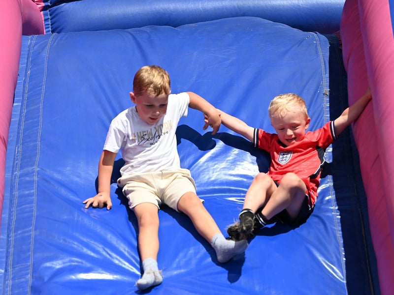 Rowan (left) and Jacob on the bouncy castle slide.