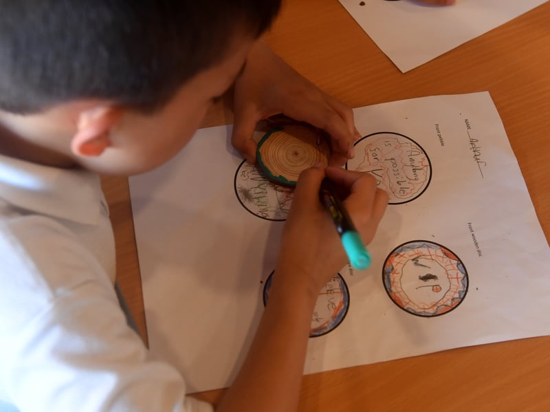 The pupils are decorating 400 pebbles and 400 wooden discs to mark the milestone
