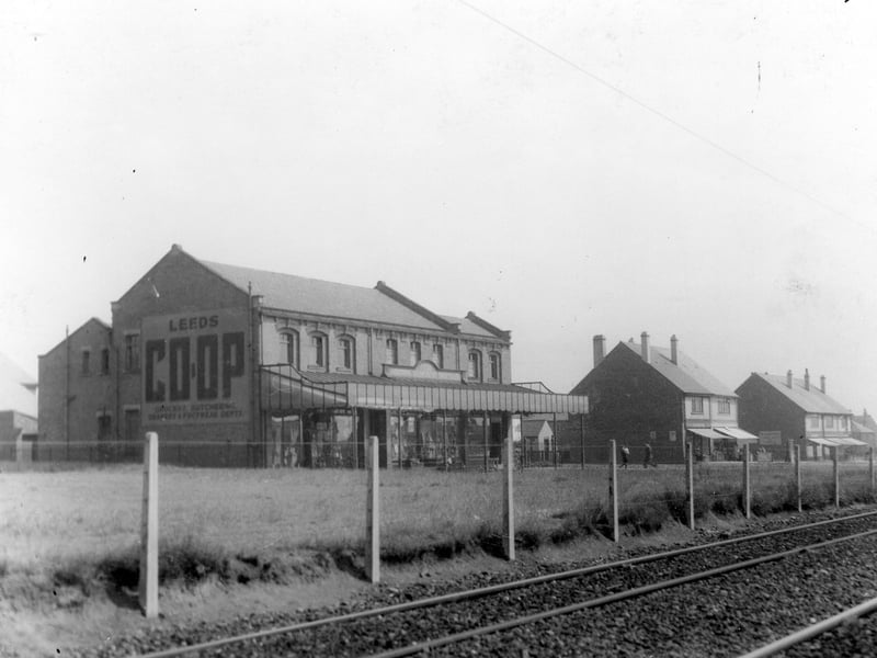 Photo of Leeds Industrial Co-operative Society store on Middleton Park Road taken from across the tramlines in July 1939. The detail is not clear, but the original shows a boy struggling with groceries and a row of shops below the Co-op.