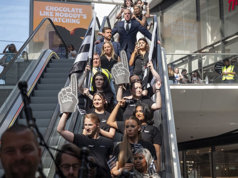 Queuers travel down the St James' Centre escalators.