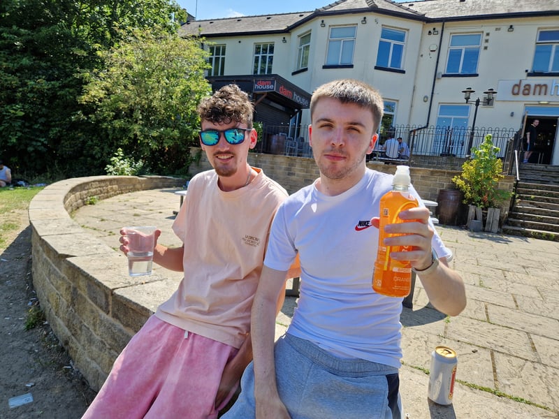Two friends cool down with soft drinks at Crookes Valley Park in the searing heat. Photo: David Kessen, Iconic Media