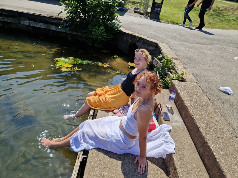 Two young women cool their feet off in the water at Crookes Valley Park. Photo: David Kessen, Iconic Media