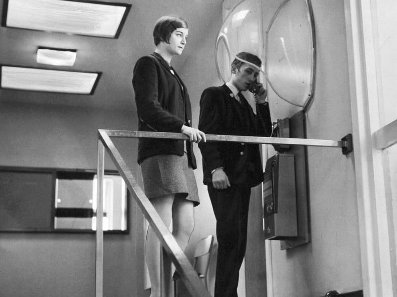 Pupils at Corpus Christi Roman Catholic Secondary School, in Leeds, use a telephone in the corridor in March 1968