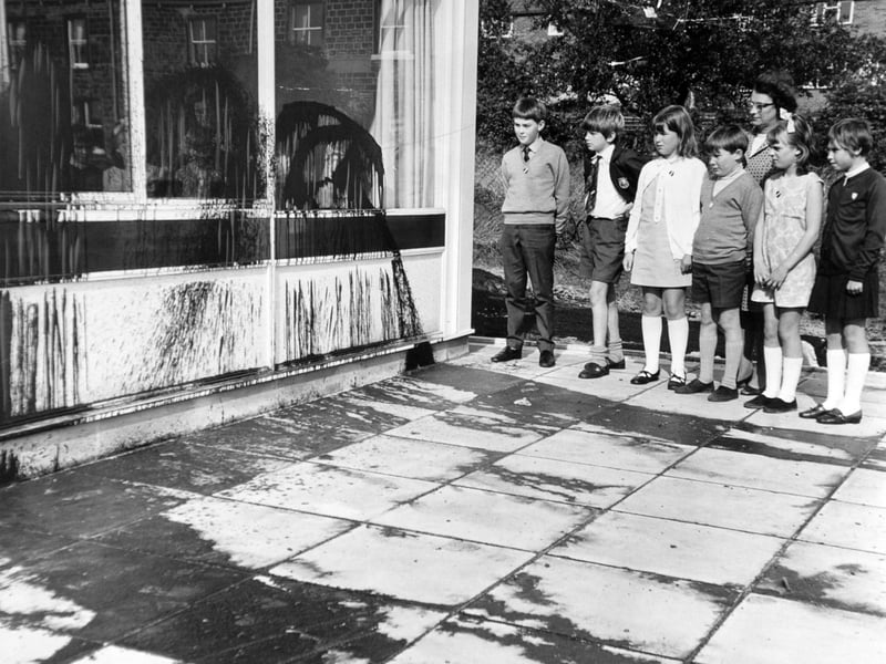 Pupils of Greenhill County Primary Junior School, Leeds, look at the tar that has been sprayed on their new school building in October 1969