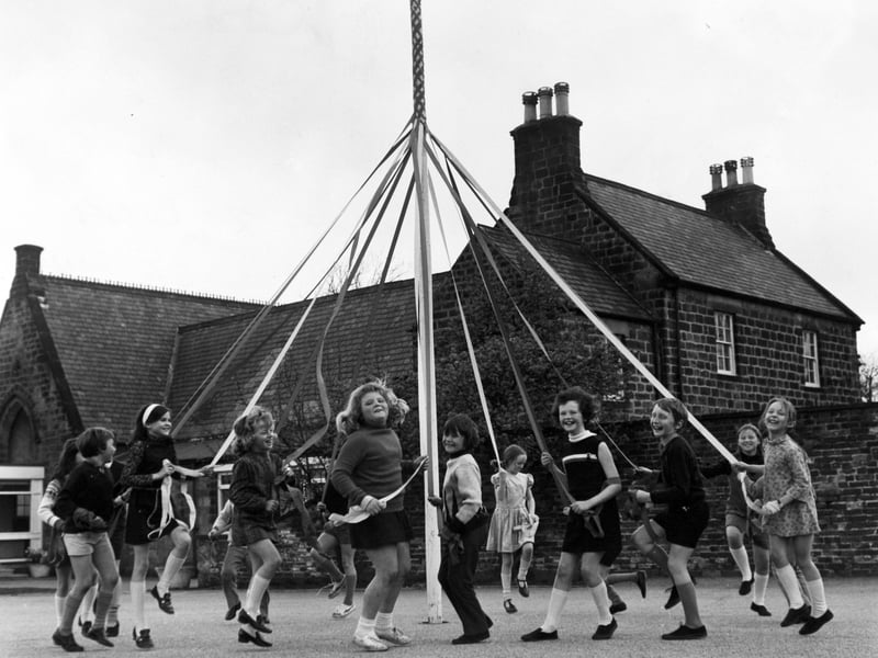 Dancing their way through to Maypole Day, children of Barwick C. E. Junior School practise the traditional dances on their own mini maypole in the school playground in April 1962