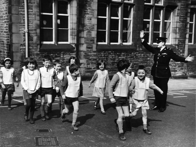 Pupils of Shipley Church of England Primary School, wear fluorescent jackets to cross busy Kirkgate in April 1968, with PC Gerald Bridgmen keeping a watchful eye