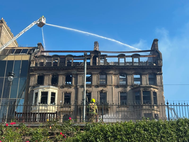 A firefighter looks on at the operation to ensure the fire is completely out.