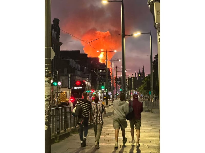 People watch the blaze on Princes Street in the early hours of Thursday morning.