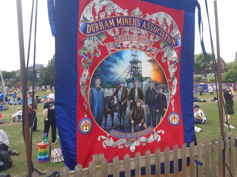 One of the banners carried in the parade showing a group of miners about to head down the pit.