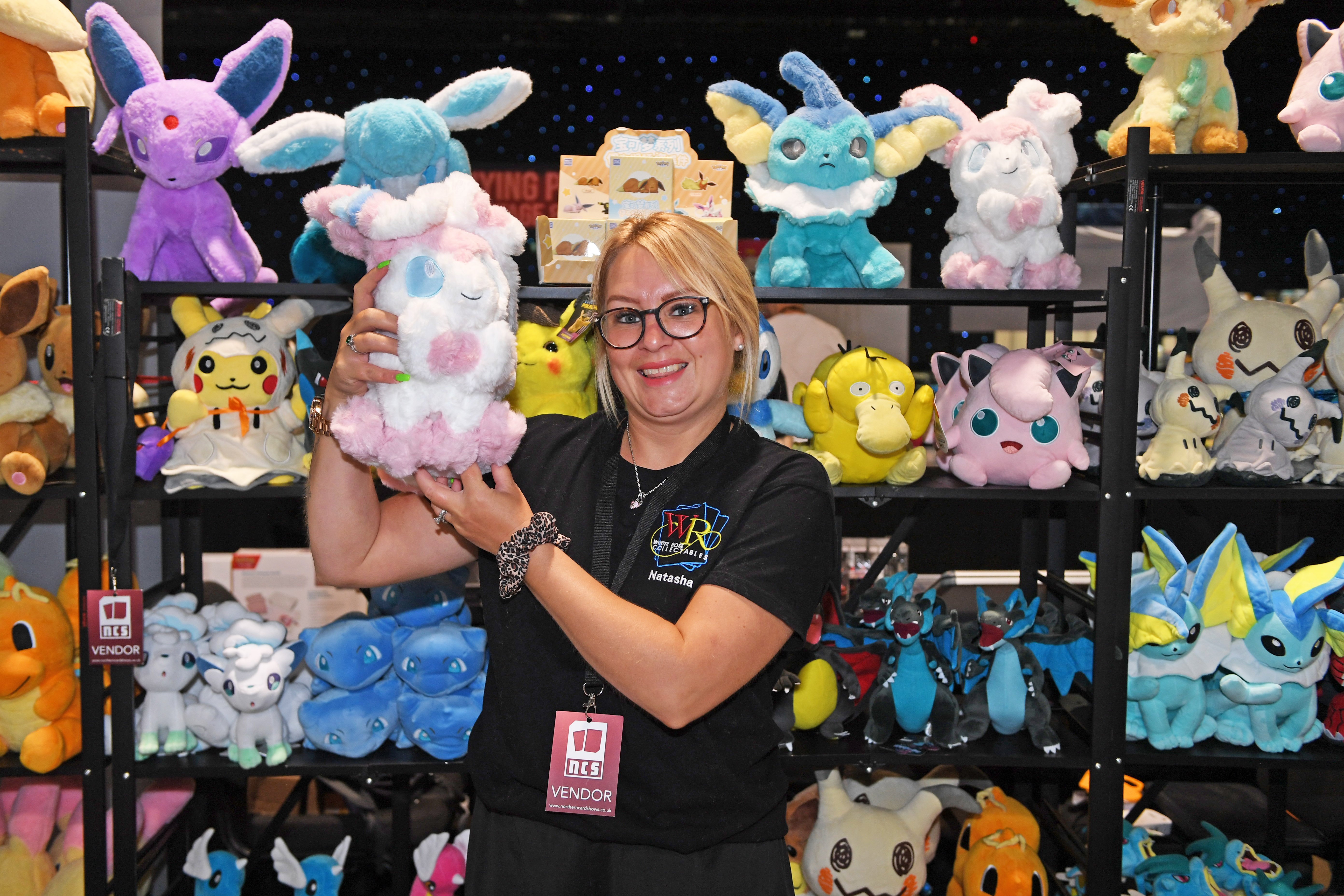 Pictured trader Natasha Ayling on her stall holding Sylveon cuddly toy. 