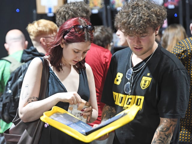 Pictured collectors view their cards