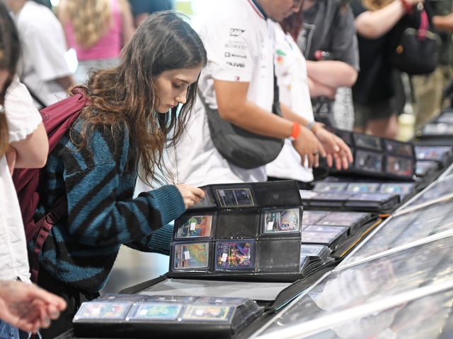 Pictured collectors view cards for sale