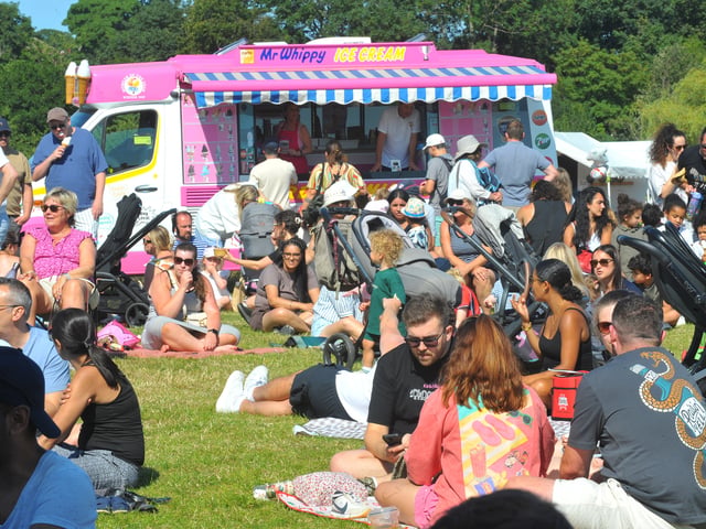A busy park and ice cream van at Moortown Festival. 