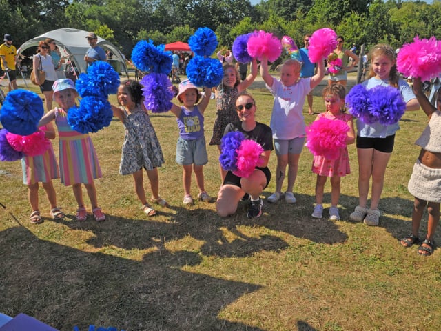 Amy Kelly Dance Academy cheerleaders workshop with some of the children in the park.