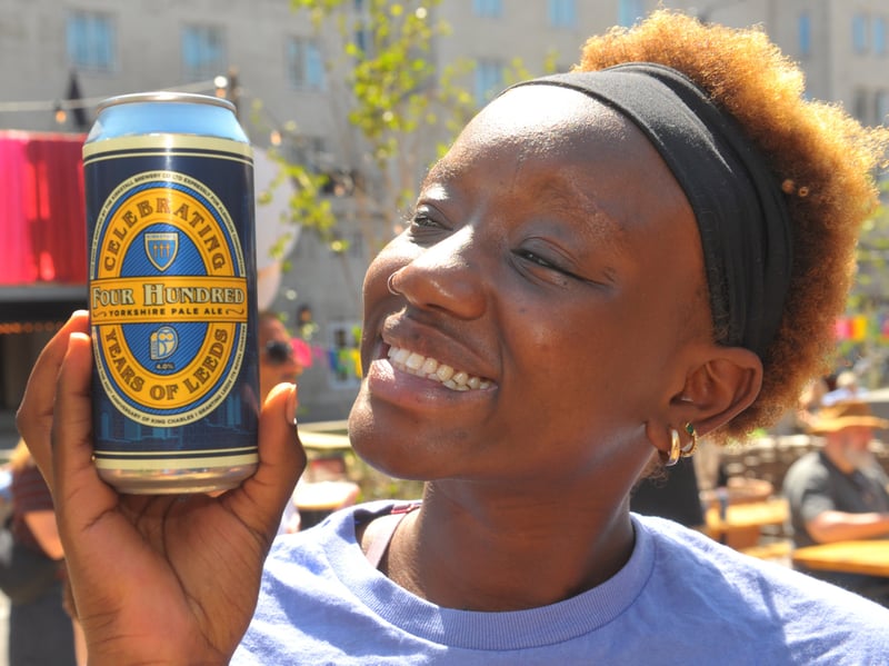 Sahara Akeno  enjoys her free can of Leeds 400 beer from Kirkstall Brewery during a birthday picnic with live music.