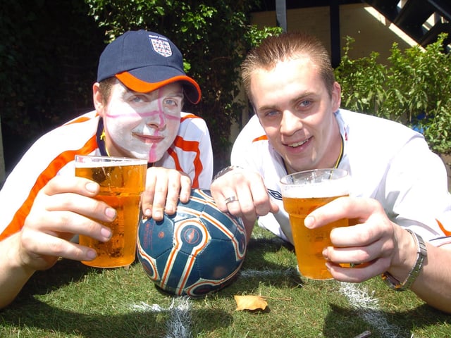 The Courtyard pub offered a grass pitch and a huge widescreen tv for the debut England World Cup match. L-R are barman Luke Wilson, 22, and Assistant Manager Nathan Hutchinson, 27 (D7387LR)