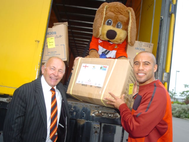 Doncaster Rovers have sent 2010 of their shirts to South Africa in preparation for the World Cup. L-R are Micky Walker, Donny Dog, and player James Chambers. 