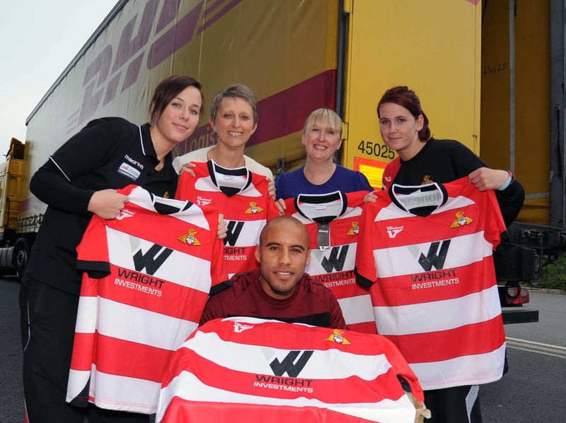 To celebrate the World Cup, Doncaster Rovers are giving away 2010 shirts to the people of South Africa. Pictured is Doncaster Rovers Defender James Chambers with Rovers staff. 