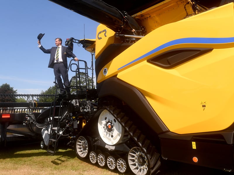 Society Manager David Tite pictured with Worlds largest Combine Harvest, the New Holland CR11.