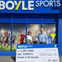Tuam local Liam Hawd being handed the 100 grand cheque