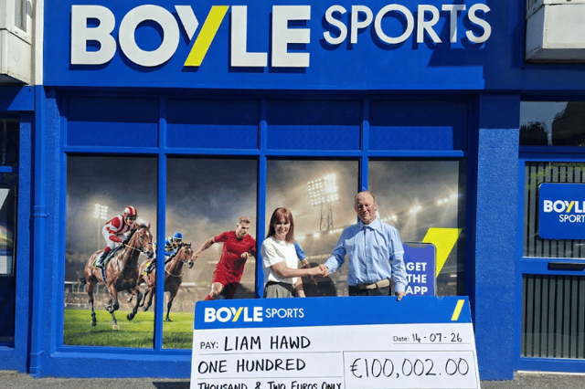 Tuam local Liam Hawd being handed the 100 grand cheque