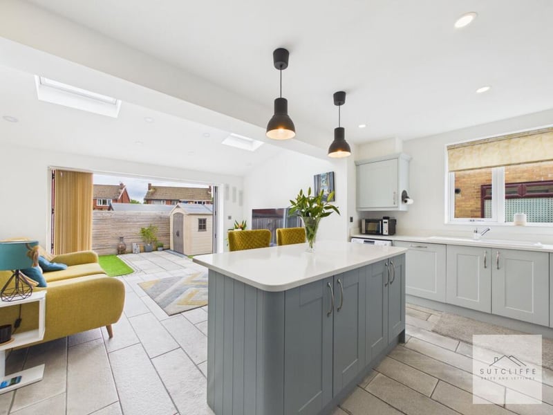 The kitchen leads on to a family room