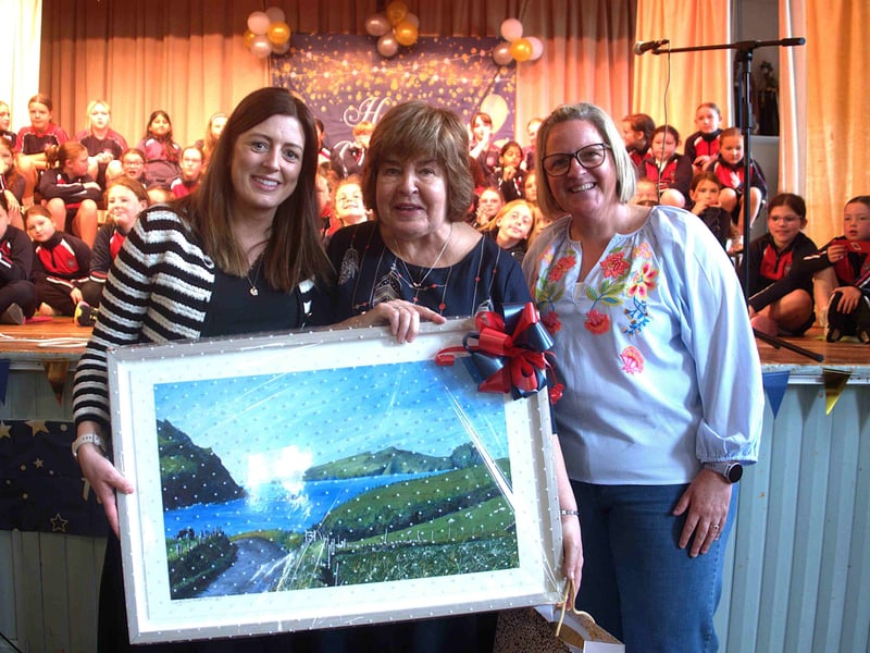 Teacher Catherine Arnold (centre) is presented with a beautiful painting by staff members Rachel Meagher and Deirdre Tyrrell 