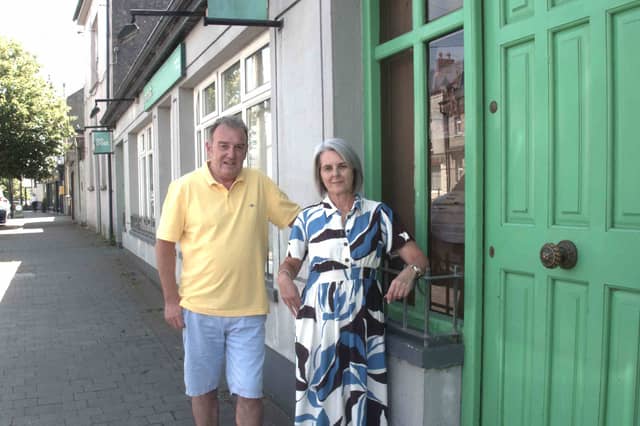 Fethard Post Office Postmaster Barry Connolly and his colleague Audrey Devine standing outside Fethard Post Office on Main Street