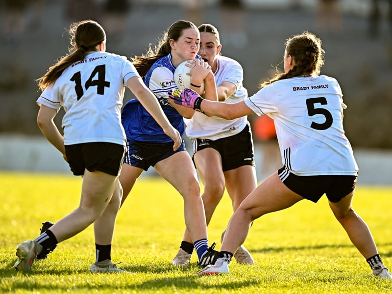 Doireann Brady of Cavan in action against Kildare players, from left, Amy Wall, Sarianna Hannick, and Kate Hill, during the 2026 AirNav Ireland All-Ireland U-16 A Championship final match between Cavan and Kildare at Páirc Chiarain in Westmeath. Photo by Seb Daly/Sportsfile