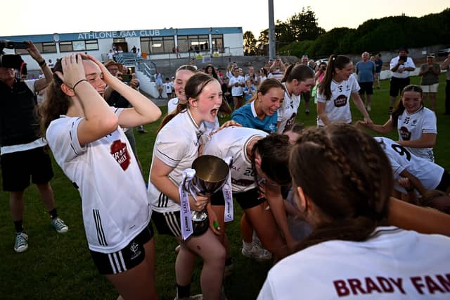 Kildare captain Amy Wall celebrates with the cup alongside teammates after the 2026 AirNav Ireland All-Ireland U-16 A Championship final match between Cavan and Kildare at Páirc Chiarain in Westmeath. Photo by Seb Daly/Sportsfile