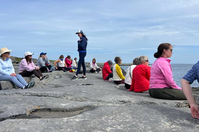 Caroline Rouine O’Connor guiding an outdoor meditation session.