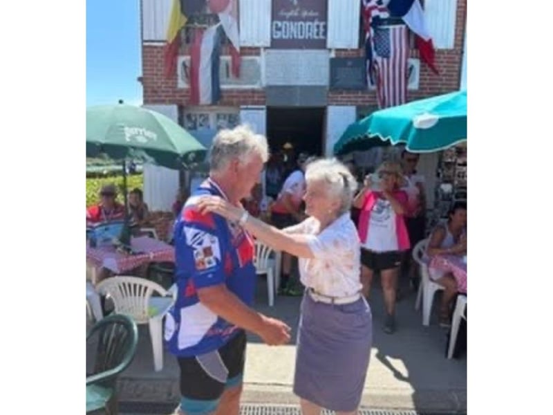 The special moment that Arlette Gondree presented Pete with his finishers at Pegasus Bridge /Cafe Gondree near Caen.