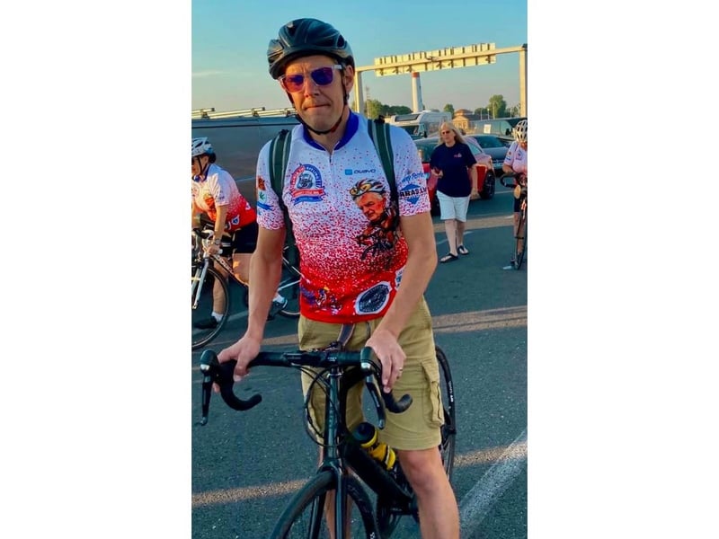 Will Loveridge gets ready to board the ferry home wearing the special cycle jerseys with a picture of Pete McQuade on them.