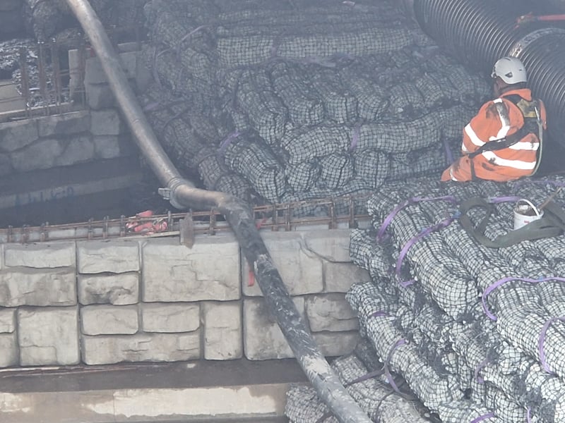A worker with material to change the flow of the Sheaf.